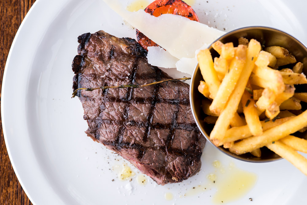plate of steak and chips with a tomato