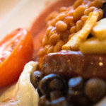 fried breakfast with beans, sausage, chips and egg