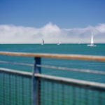 railings in front of the sea with a clear blue sky