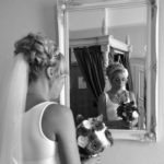 bride stood in front of a mirror