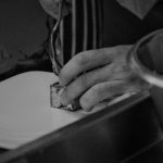 chefs handing cutting mean on a chopping board