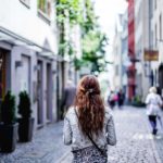 Lady walking down a cobbled street