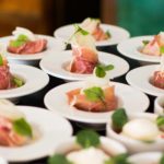 table of plates with salmon and garnish