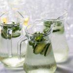 Table with glass jugs and glasses with flavoured water