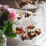 cake stand with cakes and flowers