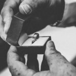 man holding wedding ring in box