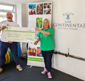 Jan (right) accepting the cheque from Adam (left) on behalf of Friends and Families